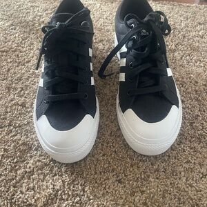 Adidas women’s Black Canvas Sneakers with White Accents platform style.